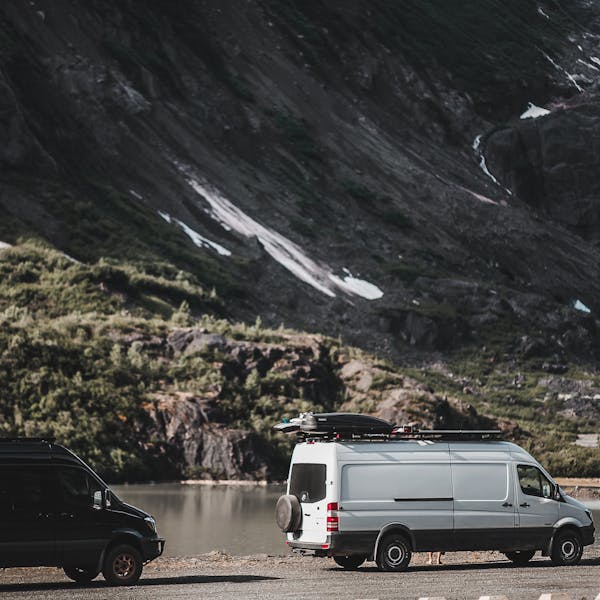 Sprinter Vans parked near a mountain