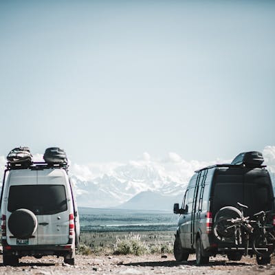 Sprinter Vans parked with a mountain view