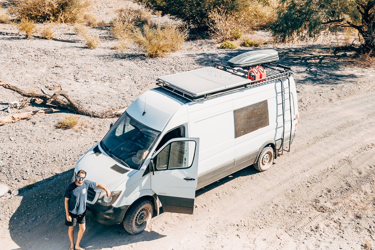 Scott and the van in sandy terrain.