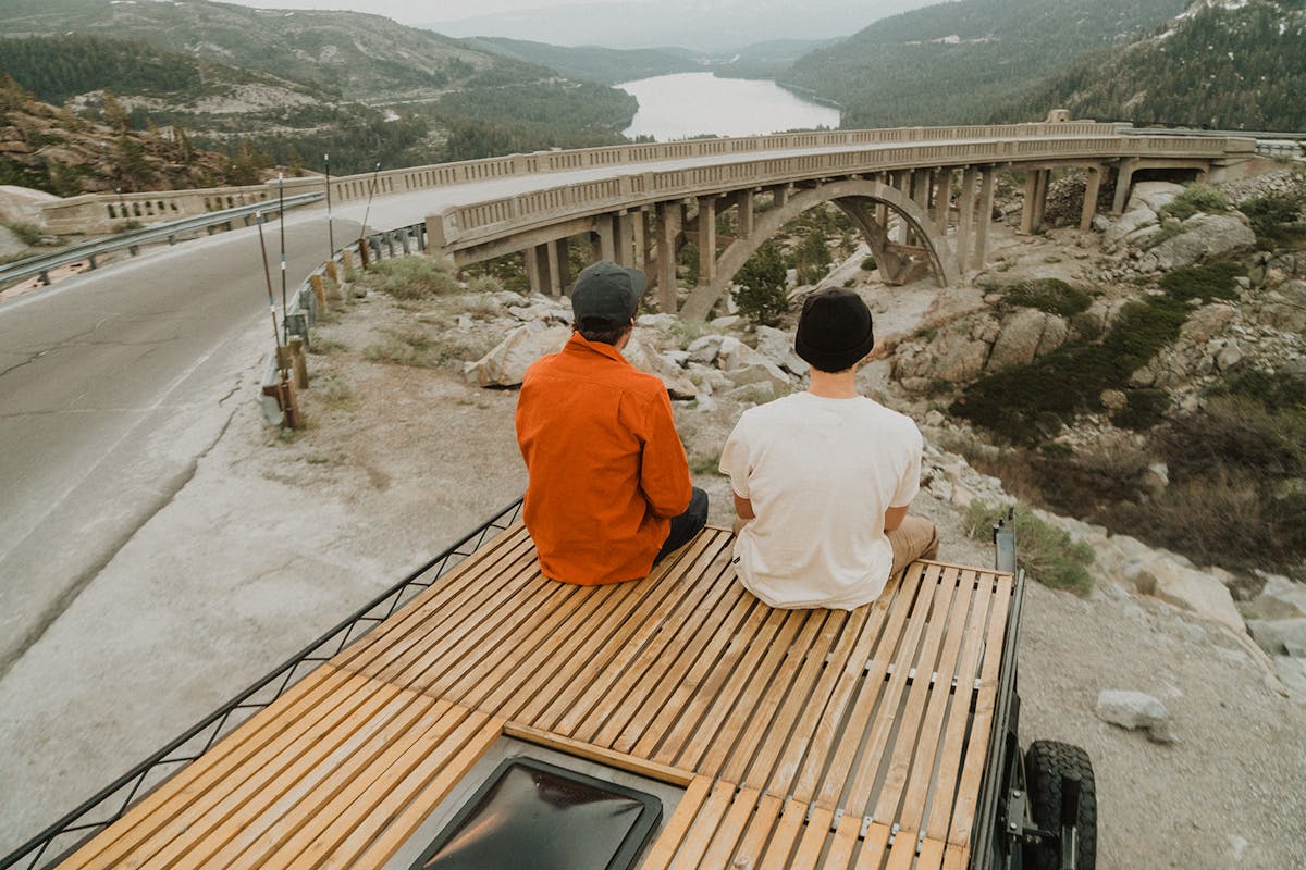 Friends sitting on the roof of the van