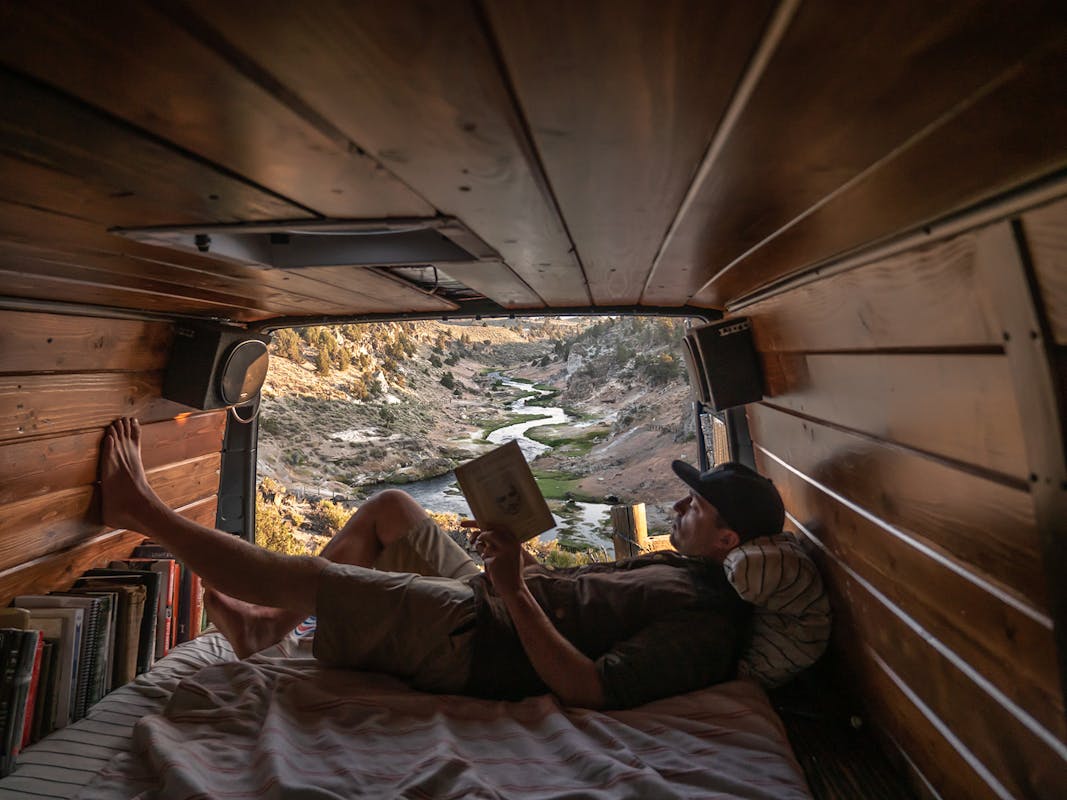 Travis reading in the van