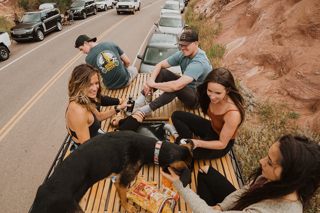 Friends hanging out on the roof of the van.