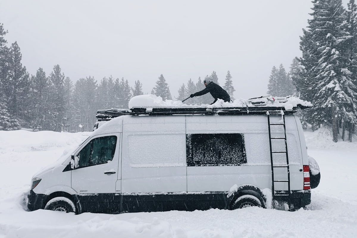 Scott shovelling the top of the van.