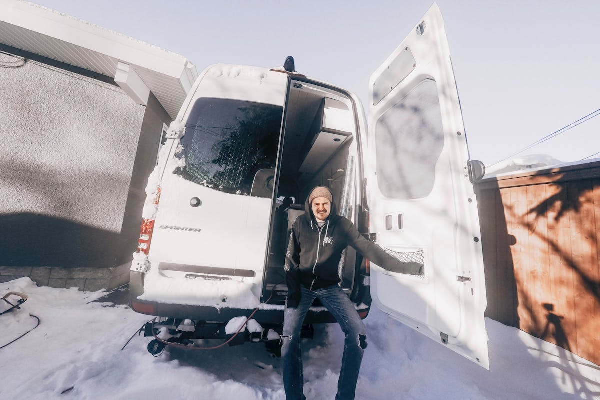 Scott sitting in the van in winter.